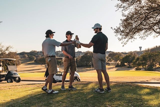 An image of guys taking a beer break on a golf course.