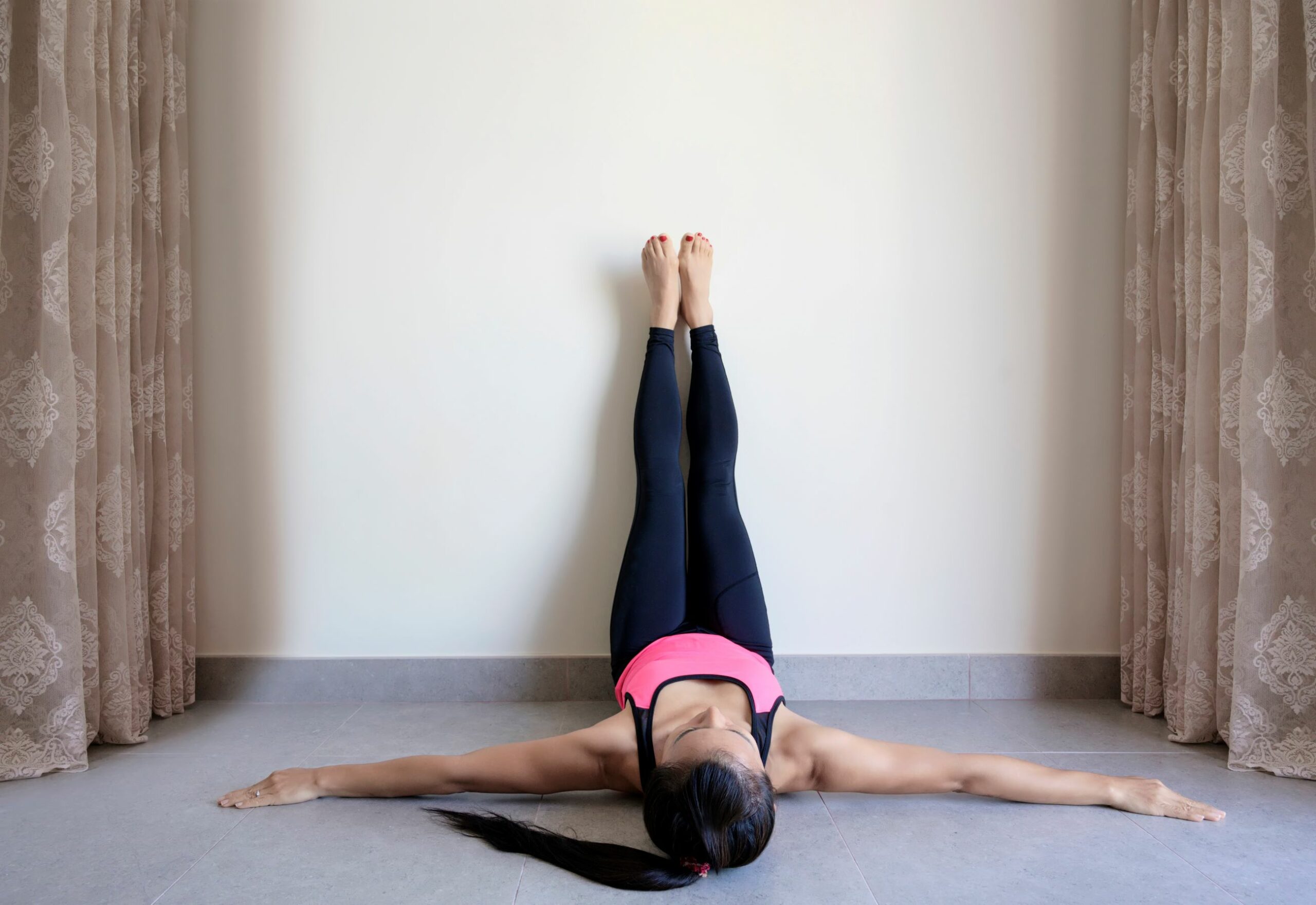 An image of a woman doing the 28 day wall Pilates challenge.