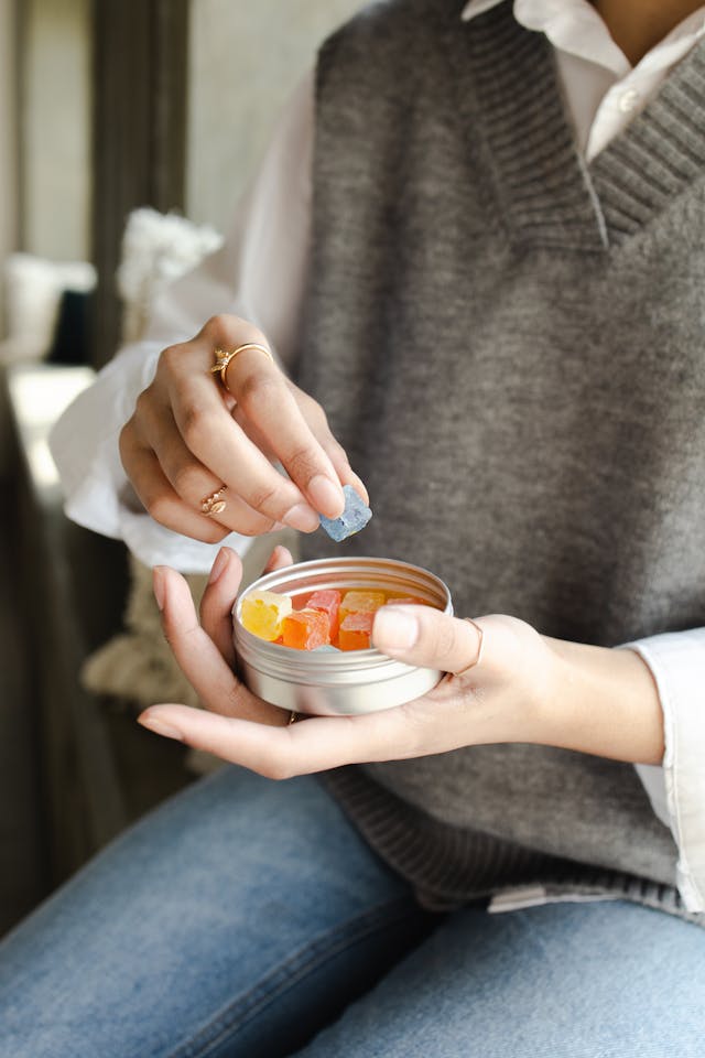 An image of someone holding a container of Delta 9 gummies.