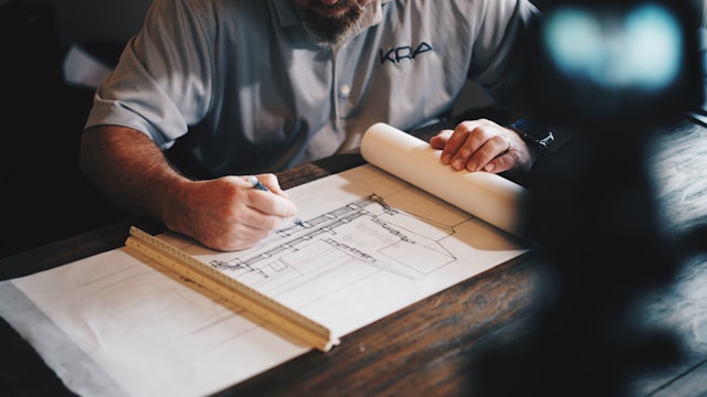 An image of a construction worker planning the remodel with a client.