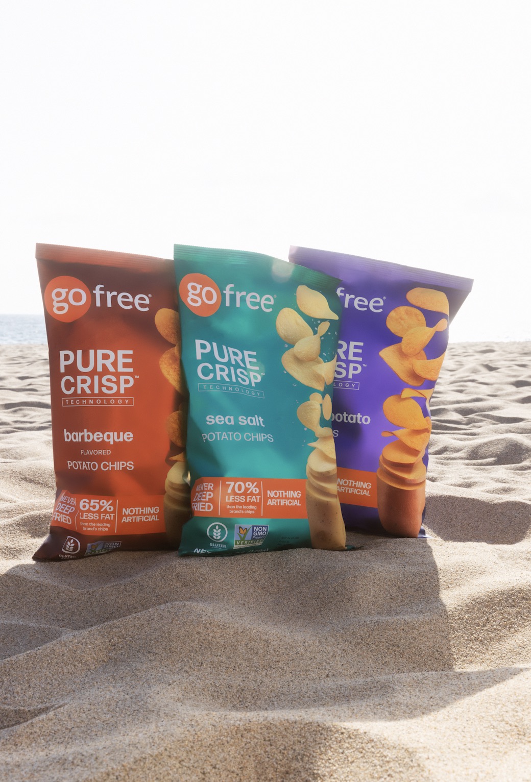 An image of GoFree Chips on sand on the beach.