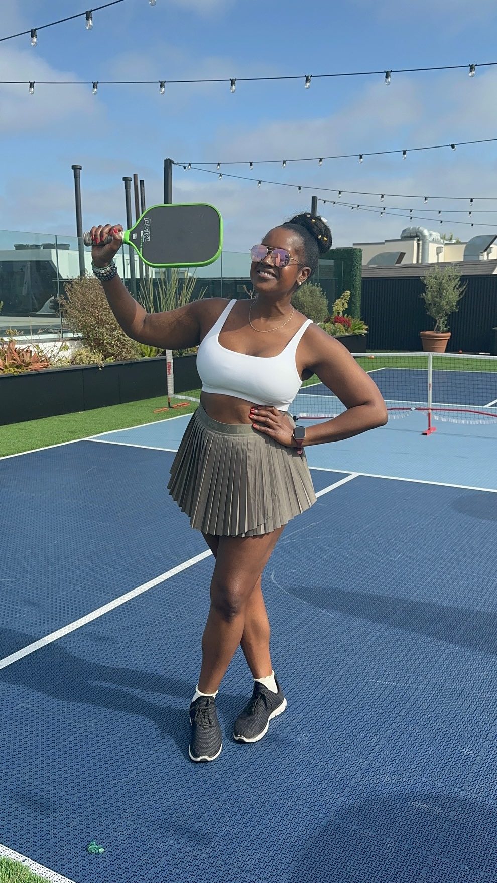 An image of lifestyle blogger Ariel playing pickleball on the rooftop of the Kimpton La Peer Hotel.