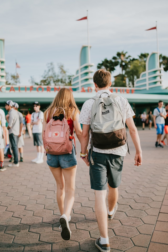 An image of two people walking in the best shoes at Disneyland, one of the best summer vacation spots.