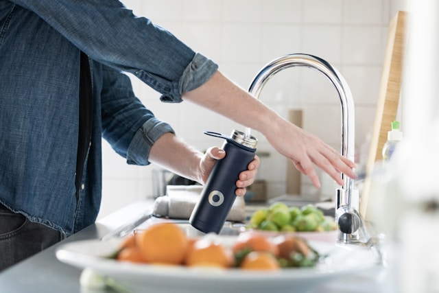 An image of someone filling their water bottle.