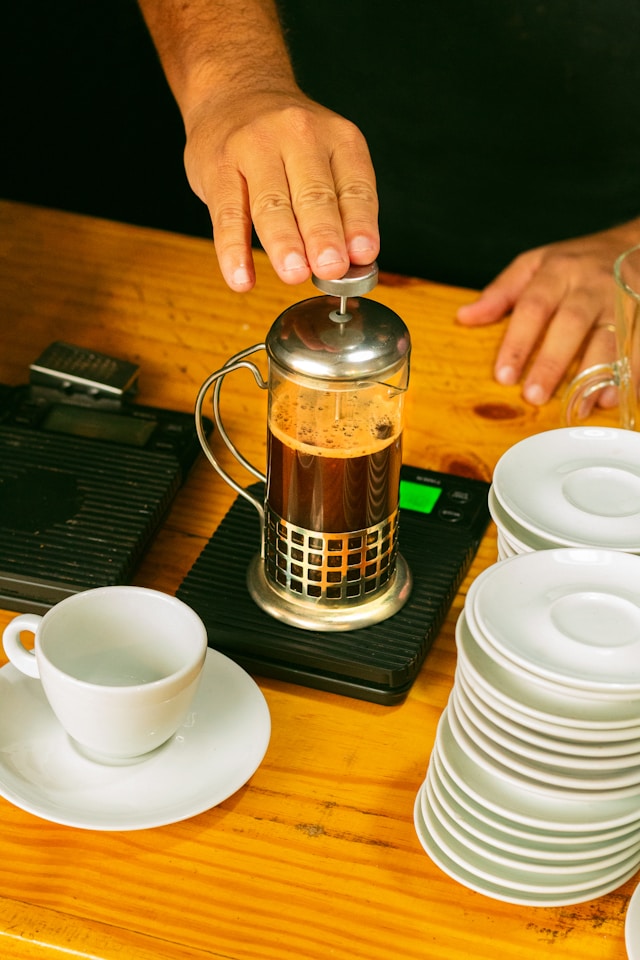 An image of someone brewing coffee with a French Press.