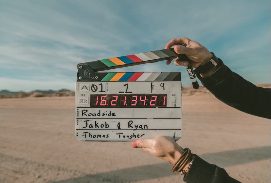 An image of someone holding a clapperboard for a movie production.