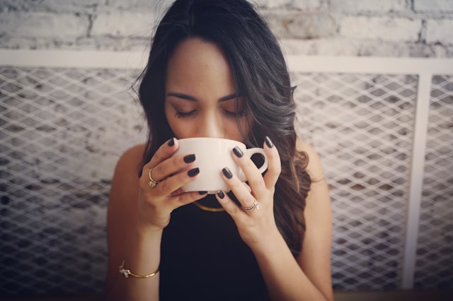 An image of a woman drinking kratom tea.