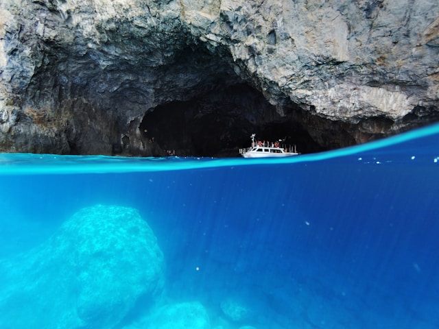 An image of a boat exploring a cave in Kythira, Greece. 