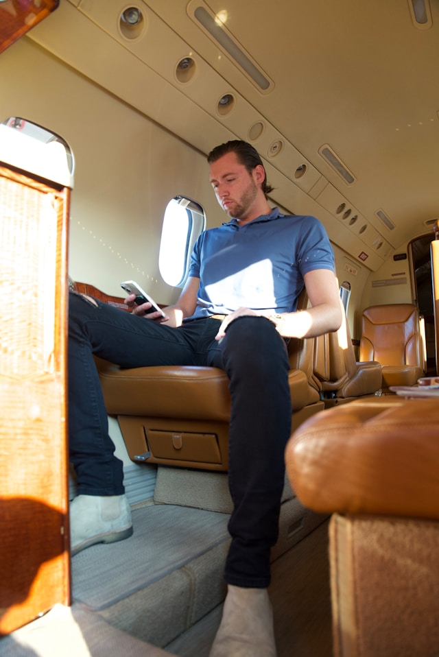 An image of a man flying on a private jet.