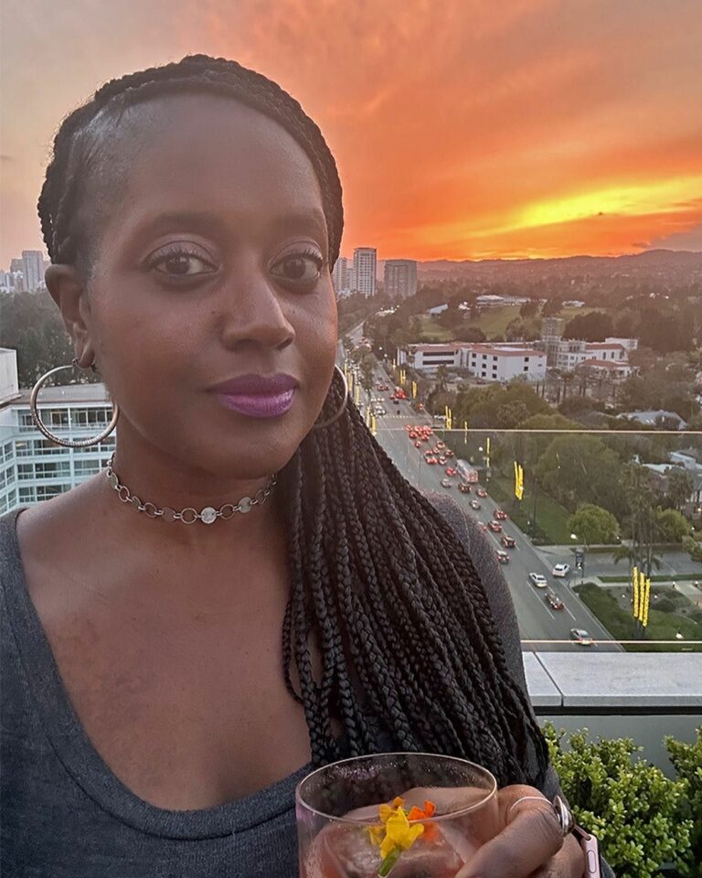 An image of lifestyle blogger Ariel watching a sunset at the JG Rooftop.