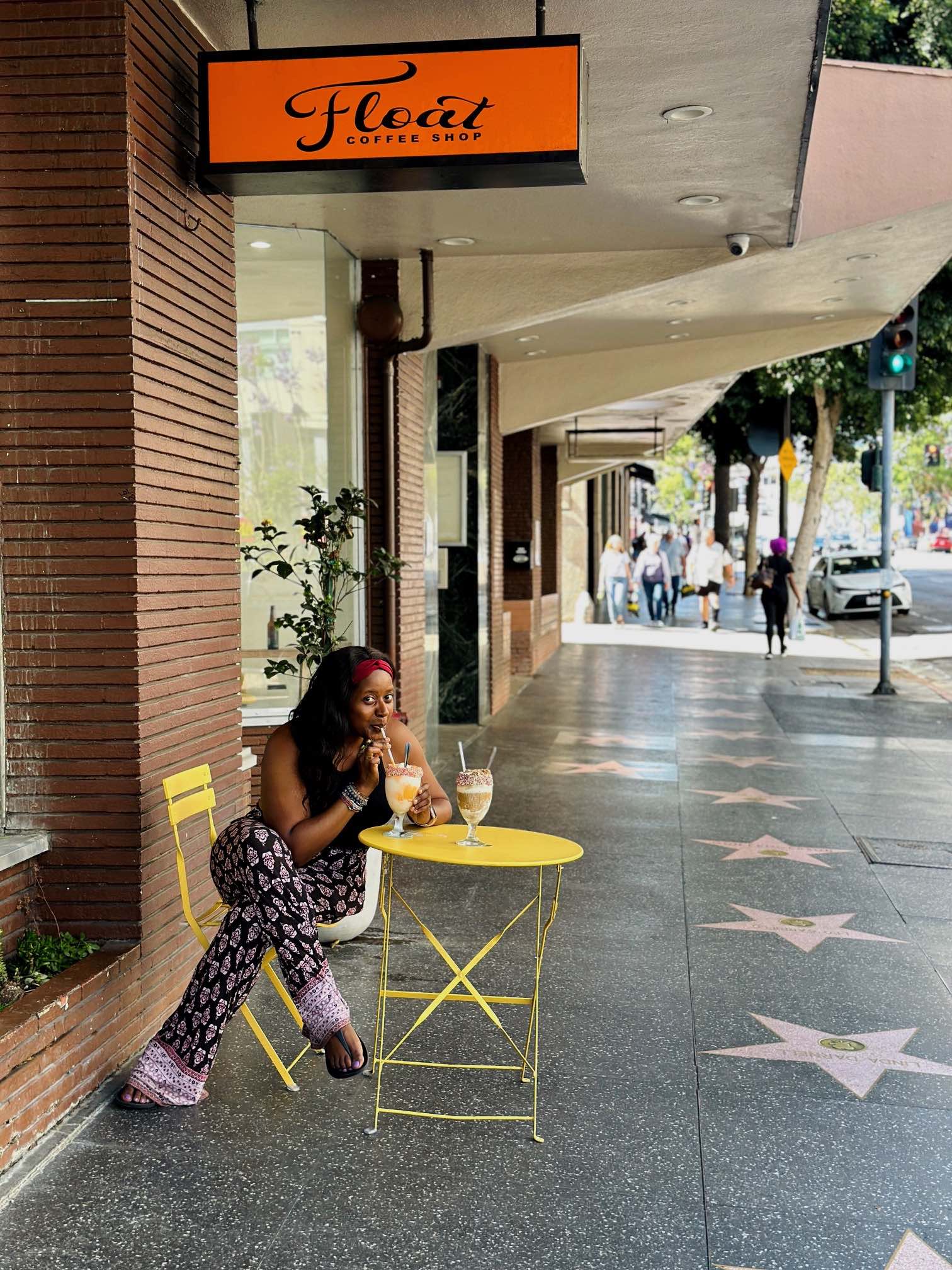 An image of lifestyle blogger Ariel sipping an ice cream float at one of the best coffee shops near me in Los Angeles, Float.