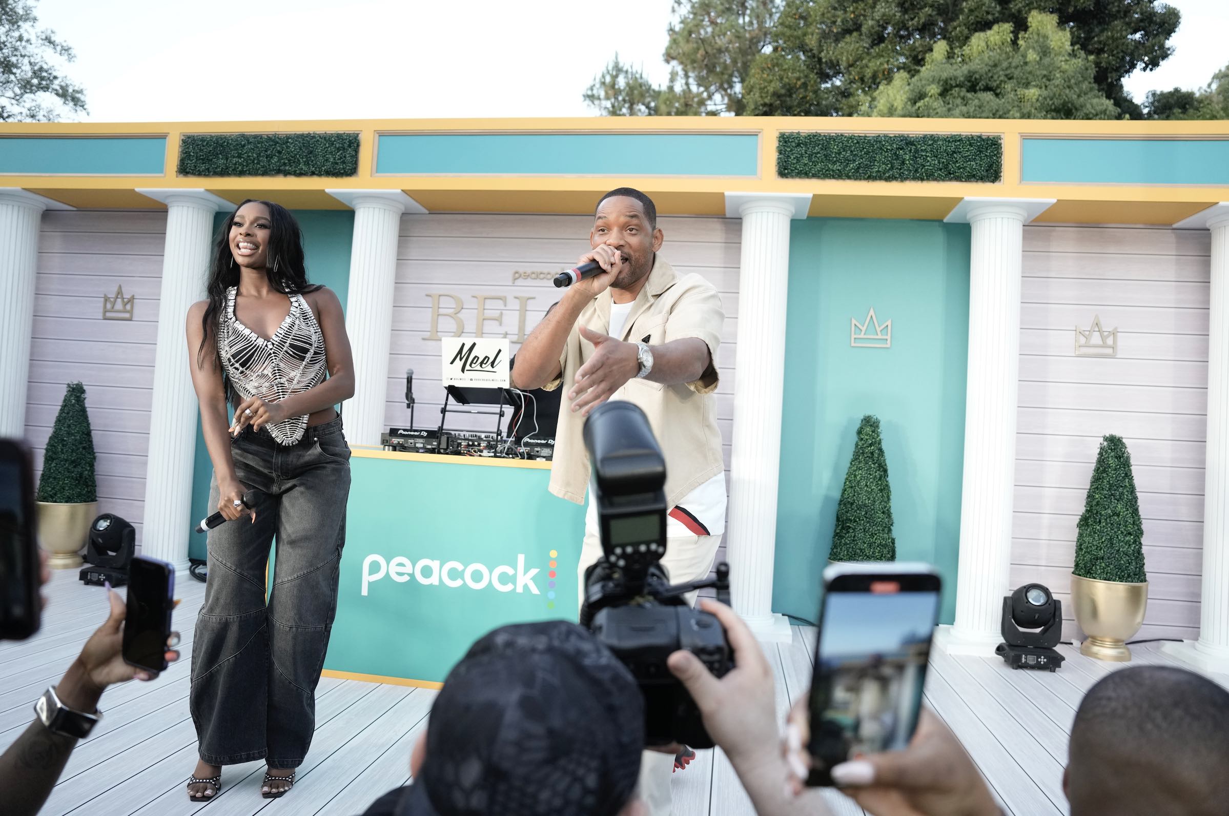 A photo of Will Smith and Coco Jones performing a duet of his classic hit "Summer" to celebrate the BEL-AIR state of mind.