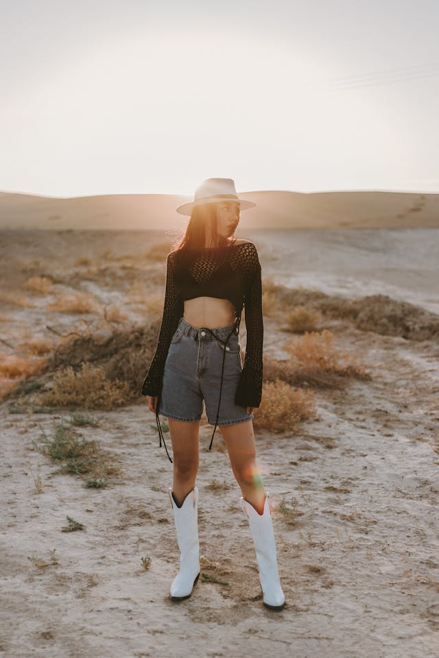 An image of a women wearing white cowboy boots.