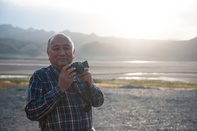 An image of a retiree enjoying retirement taking photos.