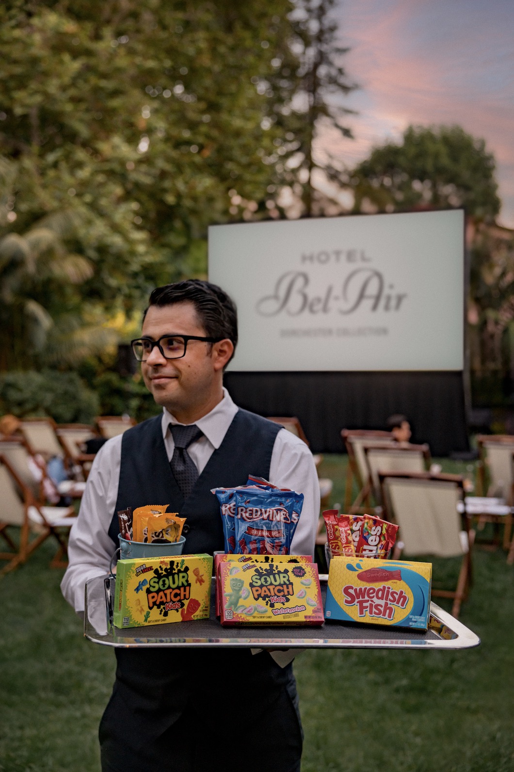 An image of a waiter holding movie theater concessions from Hotel Bel Air.