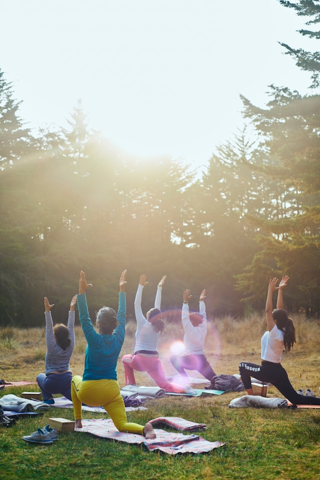 An image of several women doing outdoor yoga.