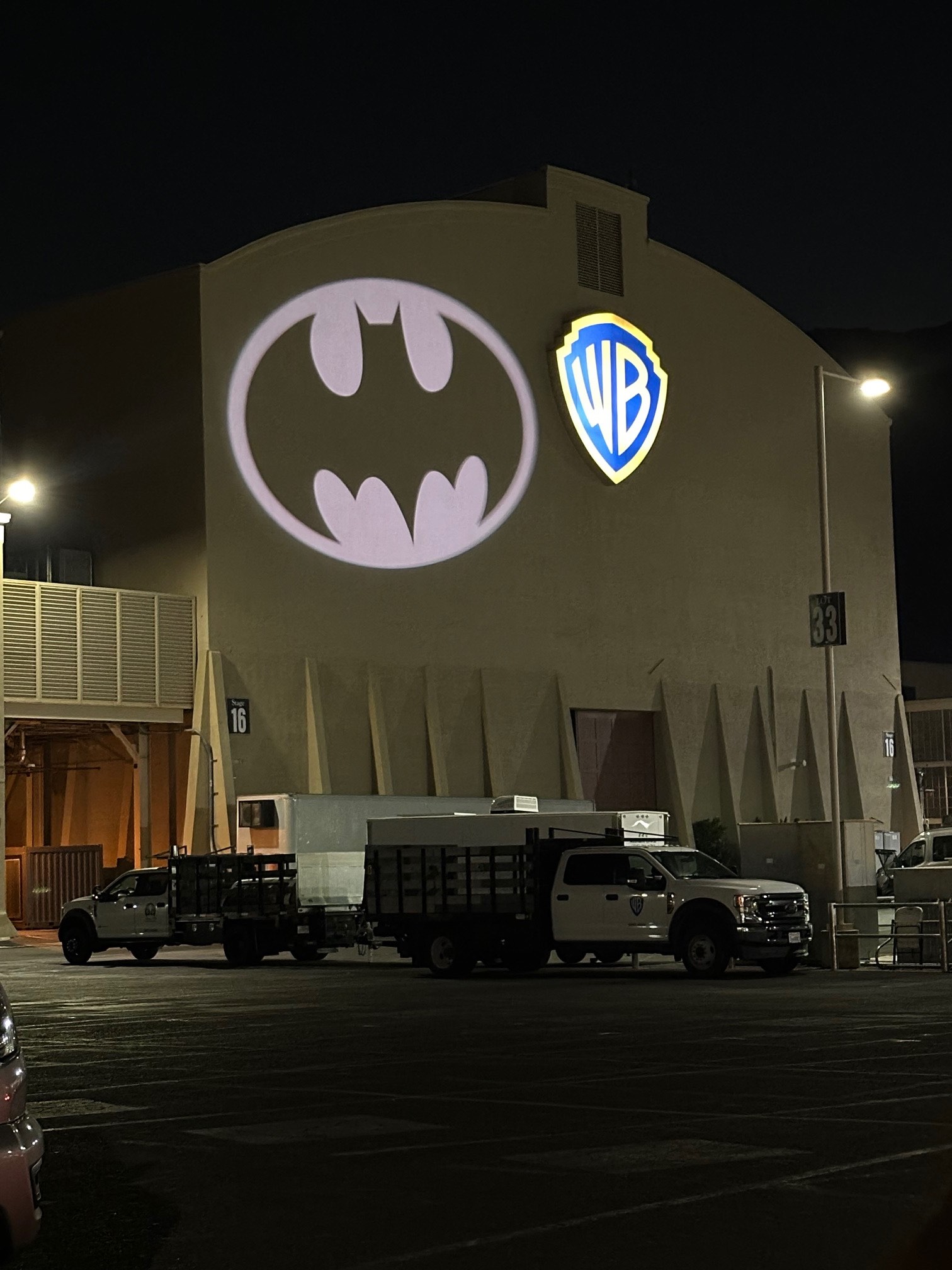 An image of the Bat-Signal and WB Logo on the side of Soundstage 16 at Warner Bros gearing up for Joker 2.