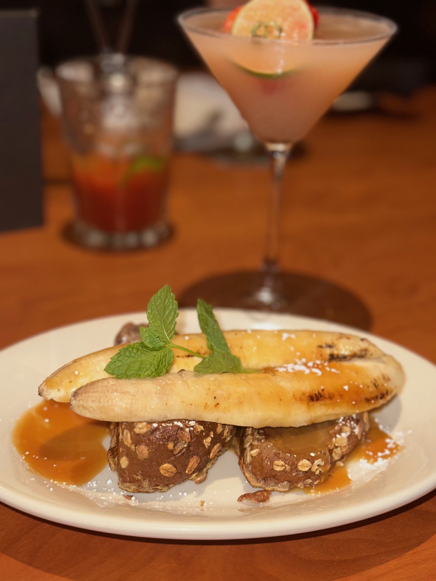 An image of the French Toast made with caramelized bananas and paired with a Lavender and Coconut Martini from Black Angus.