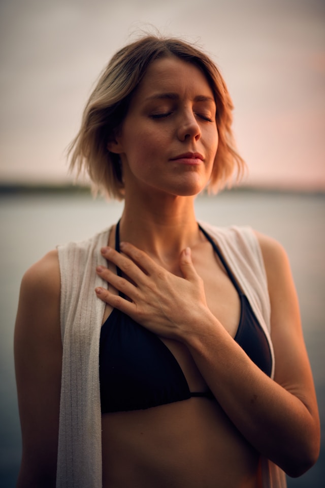 An image of a woman practicing breathwork.