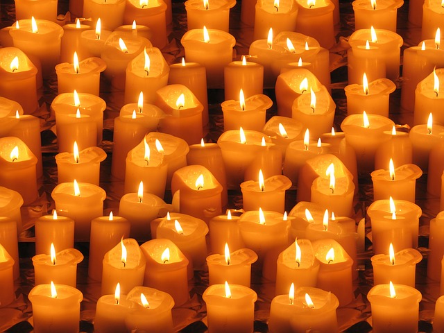 An image of lit candles for Spooky Season.