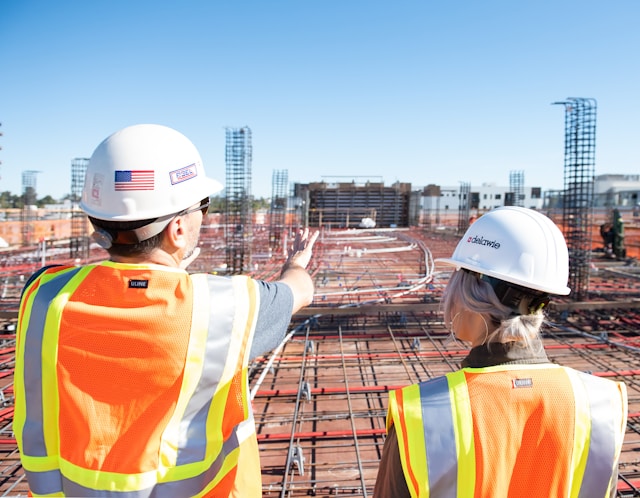 An image of two construction workers at a site.