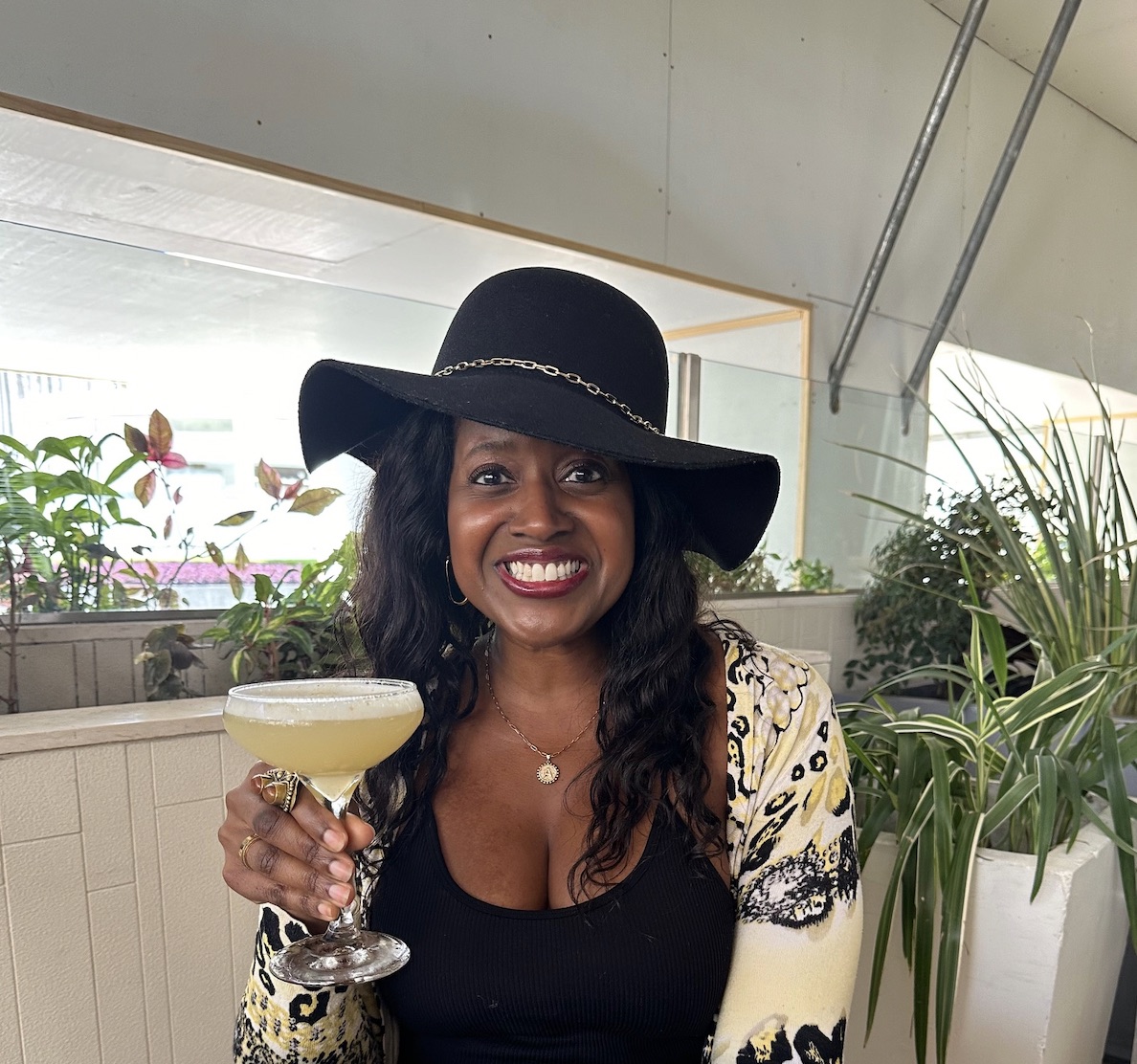 An image of lifestyle blogger Ariel holding a Yuzu Sour cocktail at Ocean Prime.