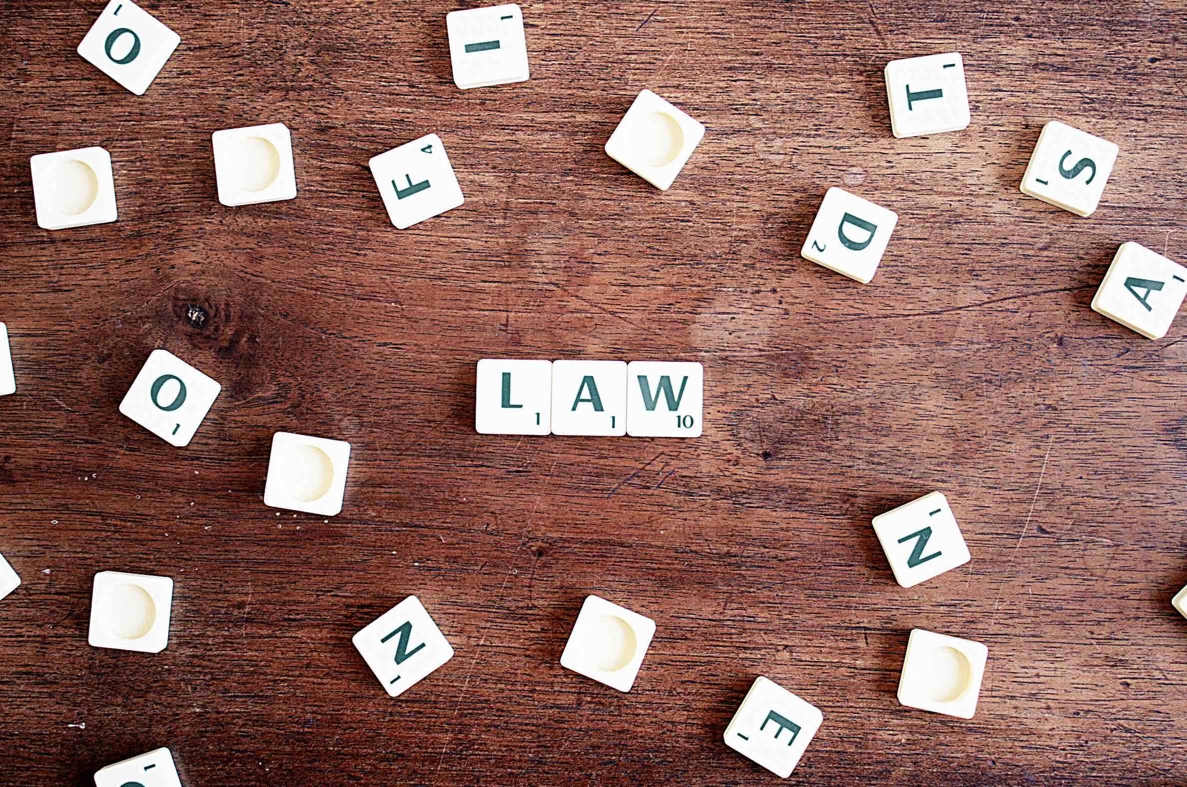 An image of scrabble tiles spelling out the word 'Law.'