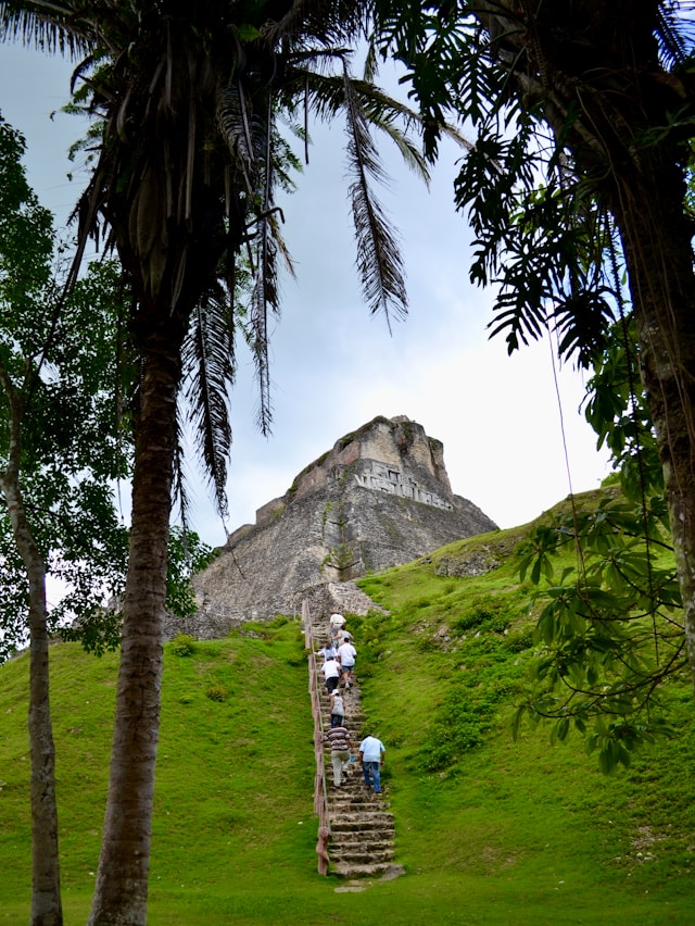 An image of people hiking Mayan ruins in Belize.