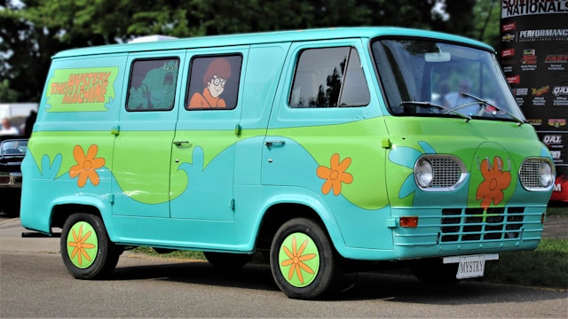 An image of Velma costume in a Scooby Doo Van for a Happy Halloween..