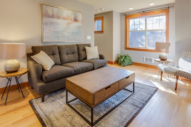 An image of a living room with decorative touches like rugs, lamps, and patterned curtains.