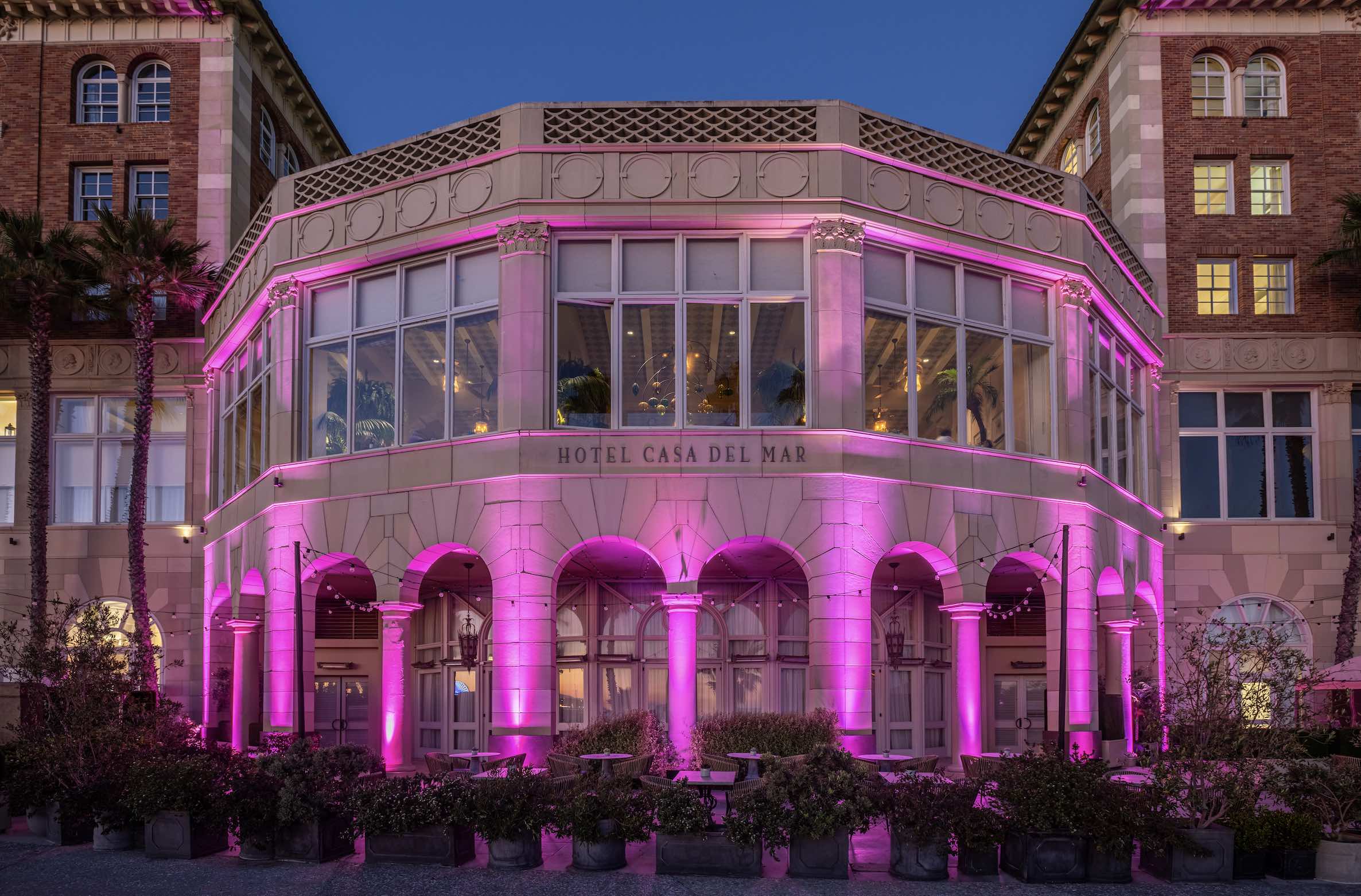 An image of Hotel Casa del Mar lit up pink for Breast Cancer Awareness Month.