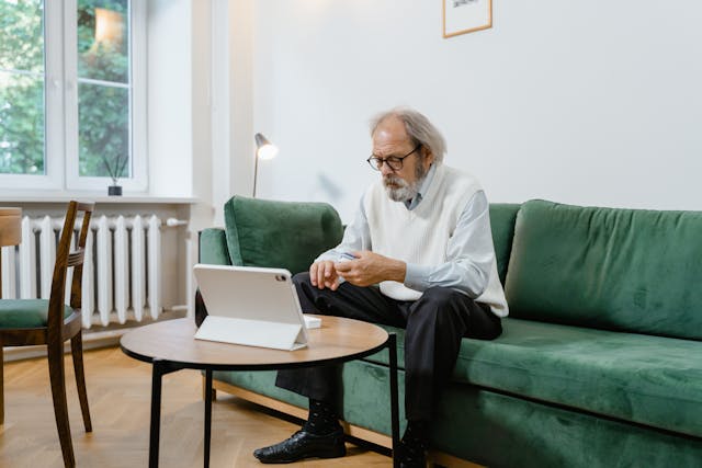 An image of a man doing a telehealth session.