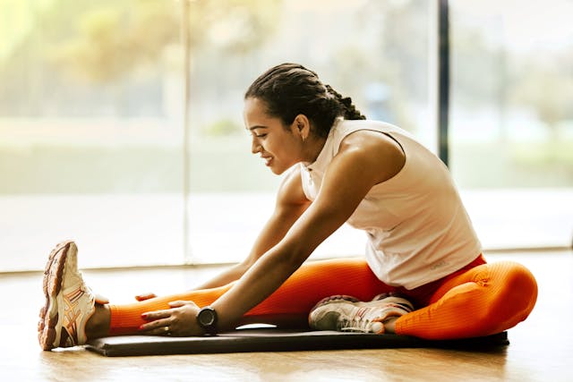 An image of a woman doing calf stretches.