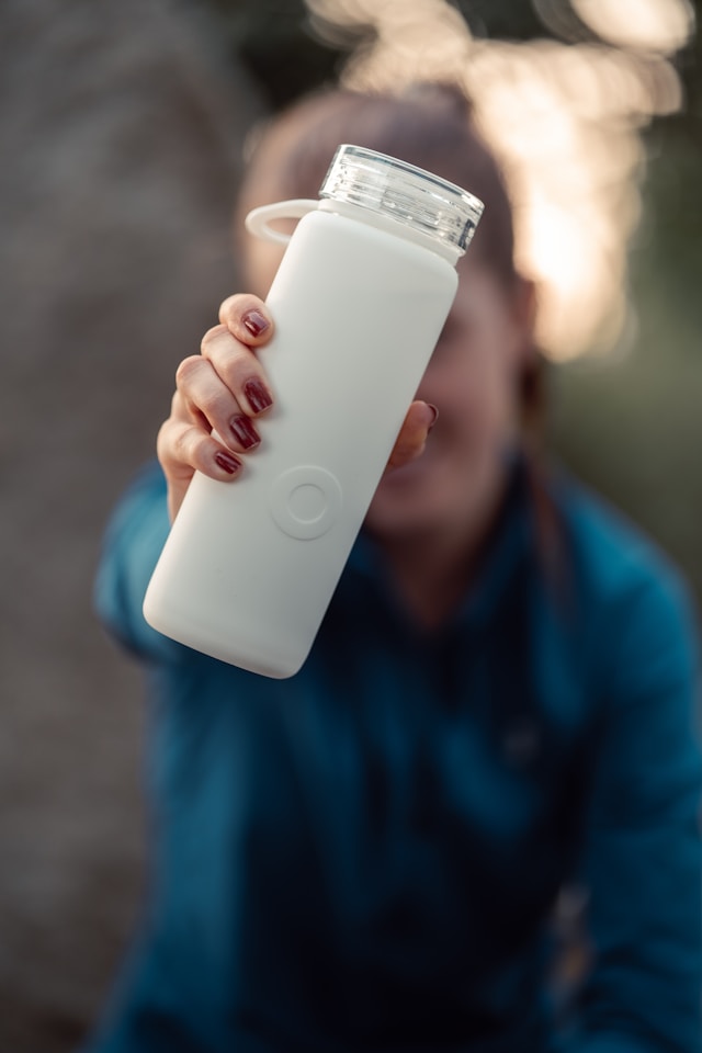 An image of a person holding a water bottle for hydration.