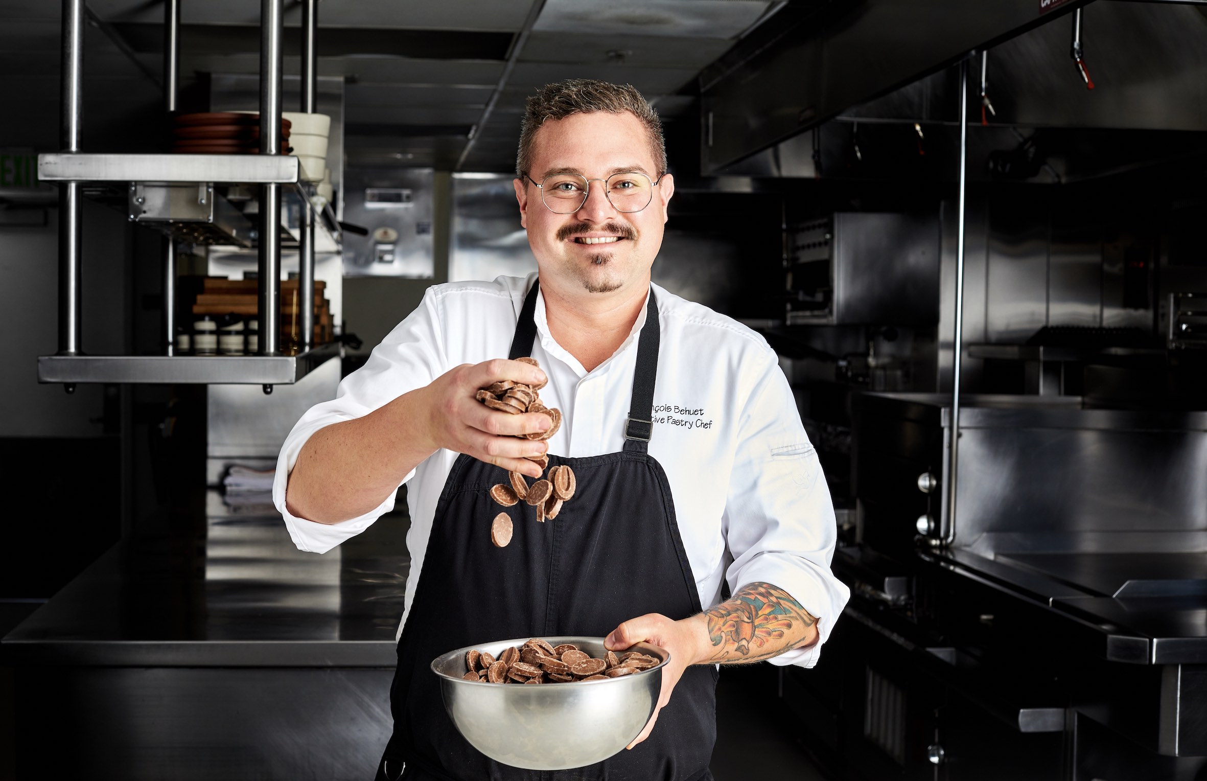 An image of Chef Francois holding dripping chocolates into a bowl.