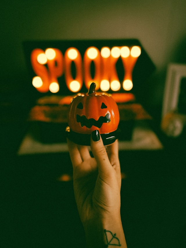 An image of a sign that says 'spooky' for Halloween party ideas and scary movie marathon ideas.