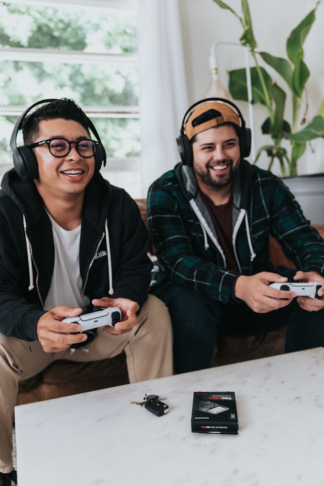 An image of two people gaming on a couch.