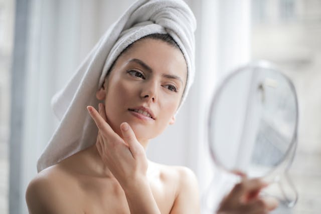 An image of a woman looking in a mirror.