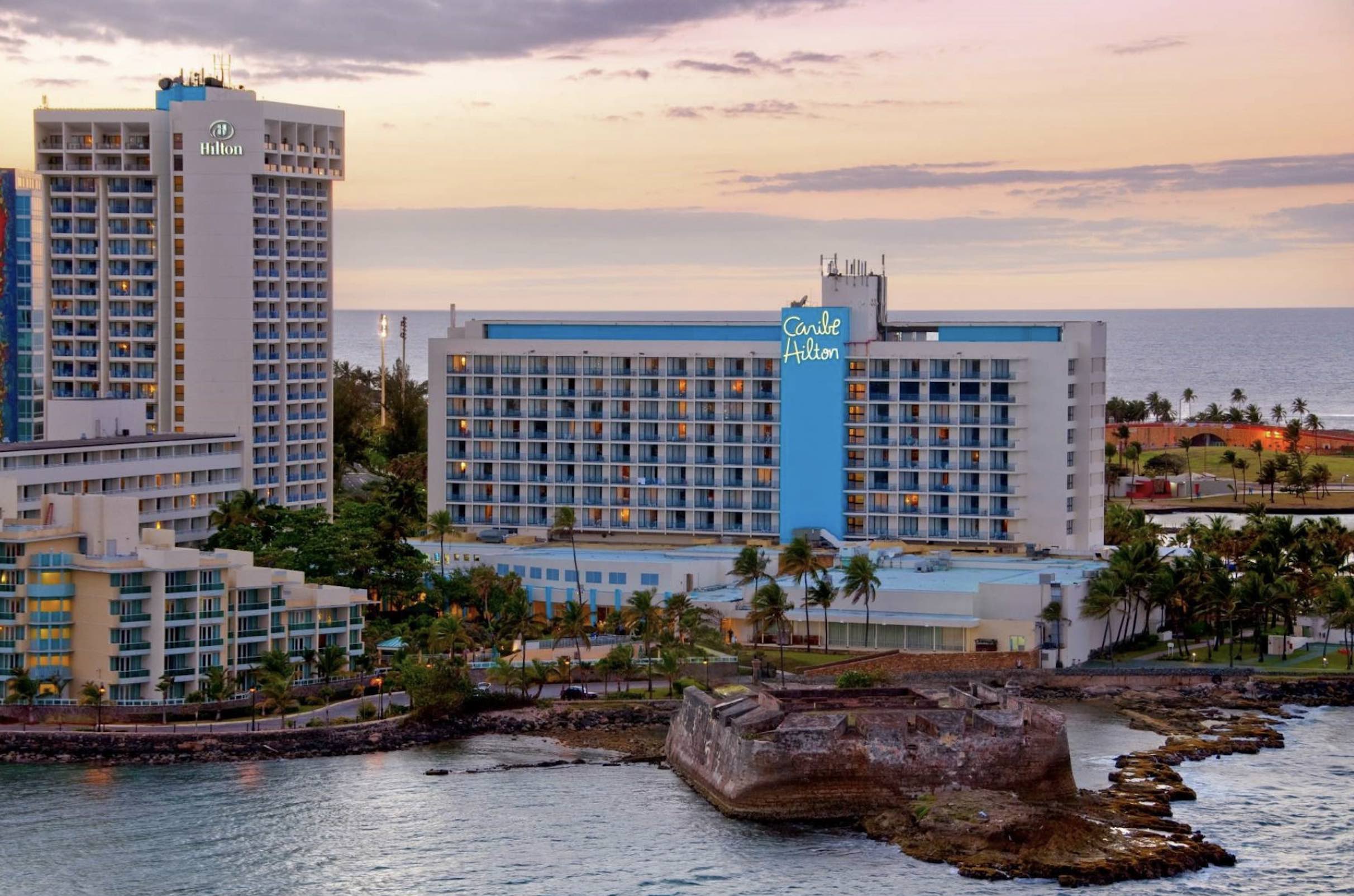 An image of the exterior of the Caribe Hilton, one of the best Cyber Monday travel deals.