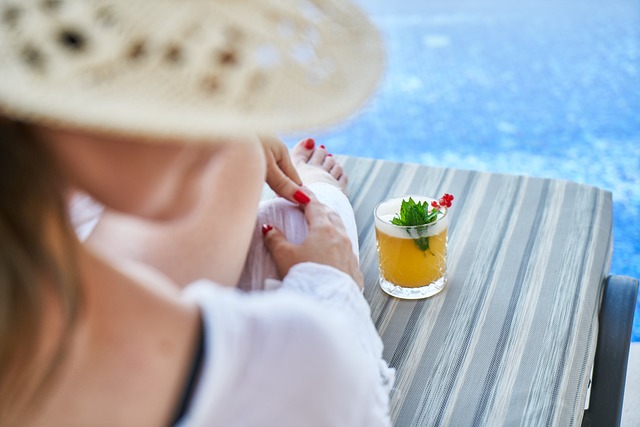 An image of a woman lounging by a pool on vacation.