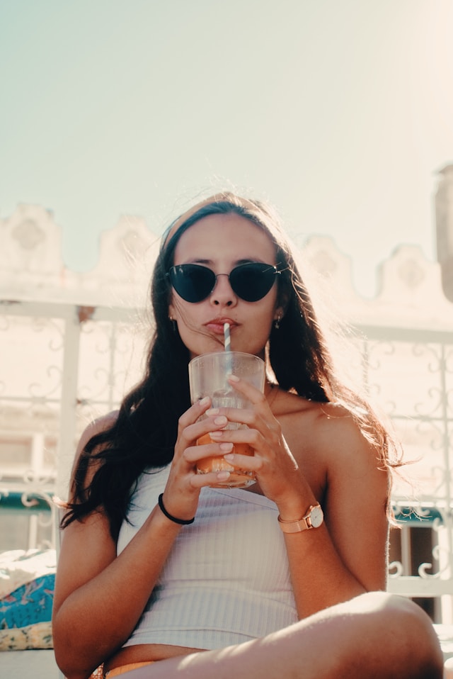 An image of a woman drinking the MomTok favorite dirty soda, The Mountain Dew Madness, perfect for binge-watching The Secret Lives of Mormon Wives.