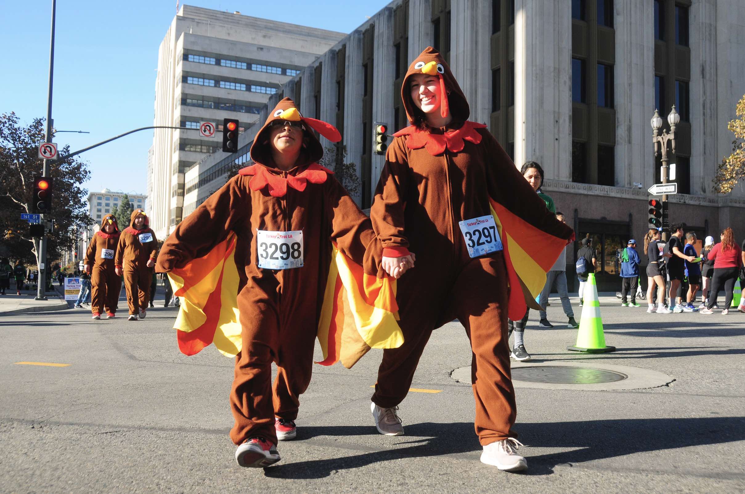 An image of two people dressed as turkeys running the Turkey Trot in LA.