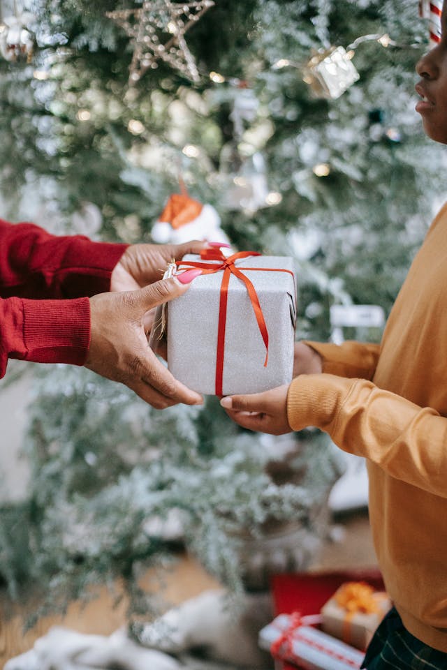 An image of someone handing a person a gift.