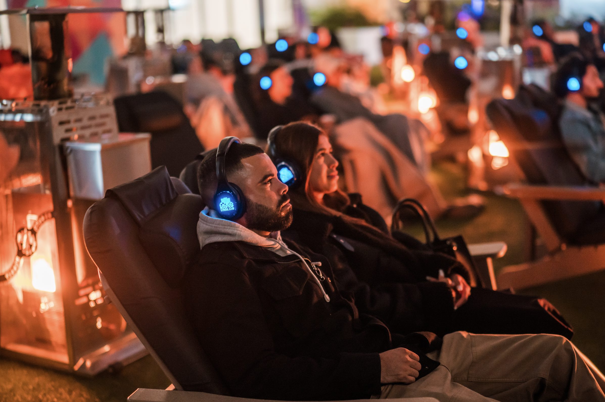 An image of people sitting at Rooftop Cinema Club for the Fireside Films series.