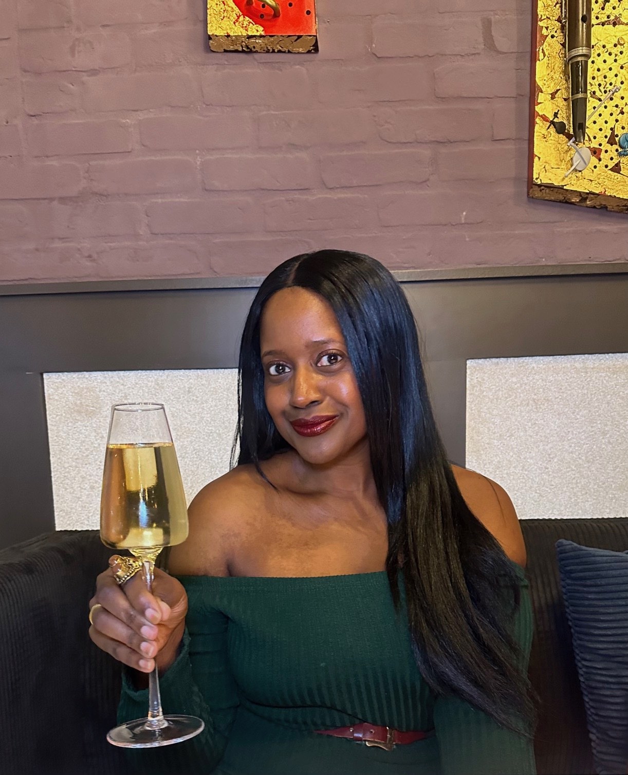 An image of lifestyle blogger Ariel with a glass of prosecco celebrating new fine dining near me.