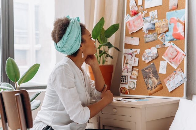 An image of a woman looking at her vision board.