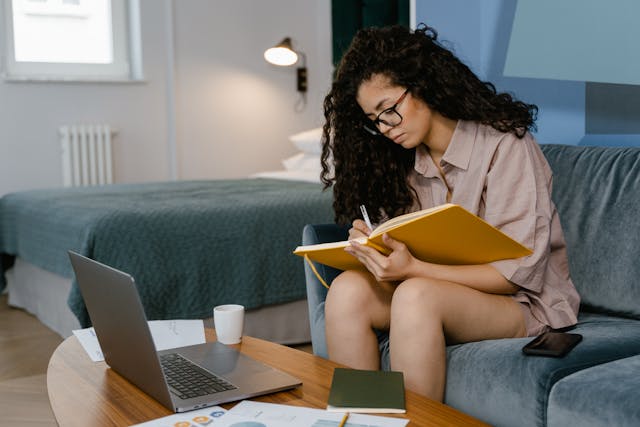 An image of a woman making money online with one of the best work from home jobs, AI prompts.