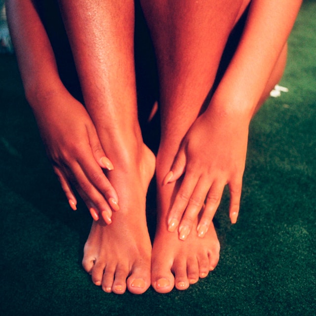 An image of a woman's manicured hands and feet.