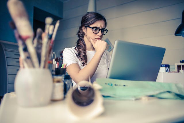 An image of a woman doing research at a computer, for one of the best work from home jobs.