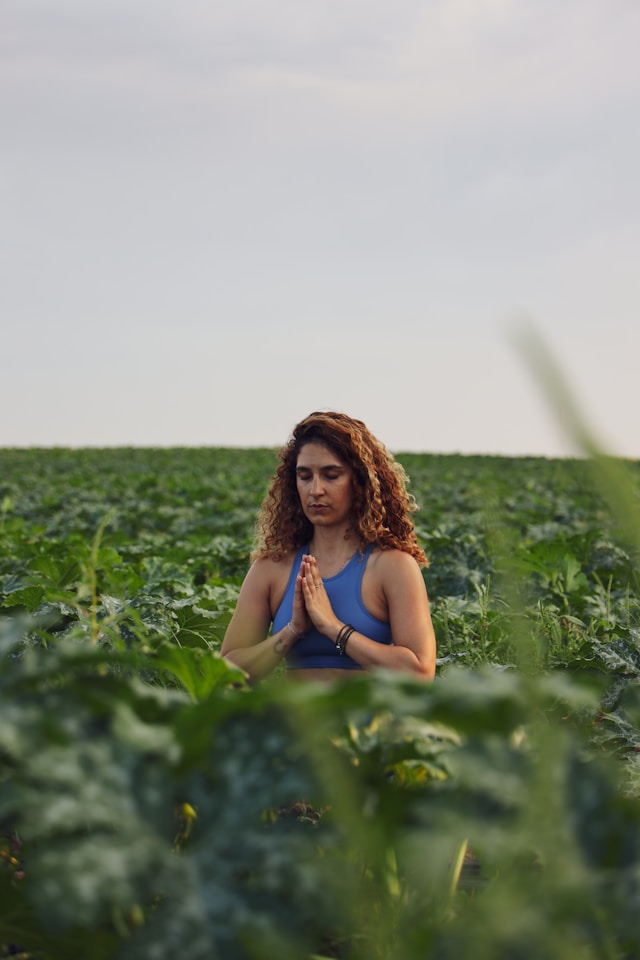 An image of a yogi sitting in prayer pose.